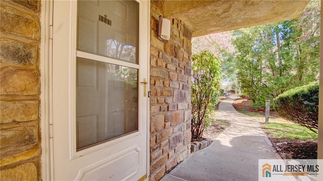 1141 Schmidt Ln, North Brunswick, NJ 08902 - entrance to property featuring stone siding and a porch