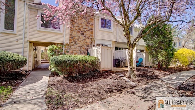 1141 Schmidt Ln, North Brunswick, NJ 08902 - view of front of home with stone siding and fence
