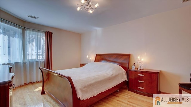 1141 Schmidt Ln, North Brunswick, NJ 08902 - bedroom featuring wood finished floors and a chandelier
