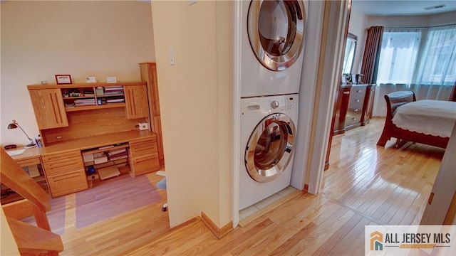 1141 Schmidt Ln, North Brunswick, NJ 08902 - washroom with estacked washer and dryer and light wood-style floors