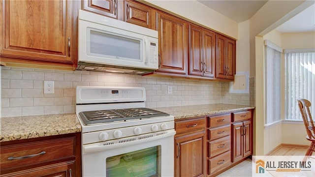 1141 Schmidt Ln, North Brunswick, NJ 08902 - kitchen featuring white appliances, light stone counters, decorative backsplash, and brown cabinets