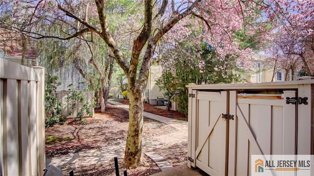 1141 Schmidt Ln, North Brunswick, NJ 08902 - view of yard featuring fence, an outdoor structure, and a storage shed