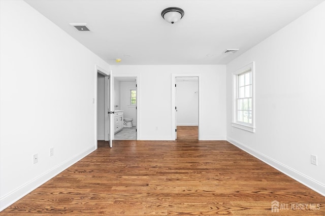 440 Ellisdale Rd, Chesterfield, NJ 08515 - unfurnished bedroom featuring connected bathroom, baseboards, visible vents, and wood finished floors