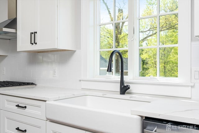 440 Ellisdale Rd, Chesterfield, NJ 08515 - kitchen with white cabinets, a healthy amount of sunlight, a sink, and wall chimney exhaust hood