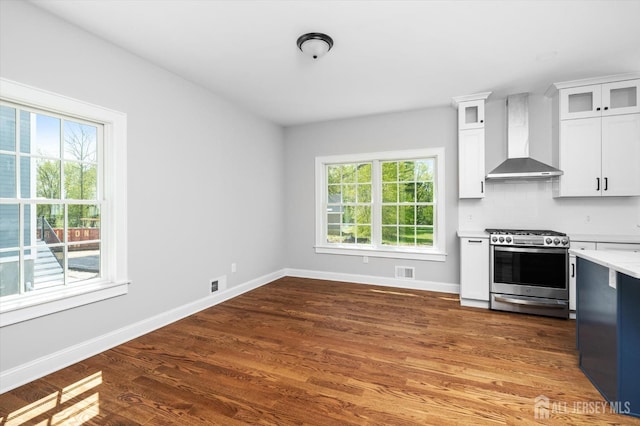 440 Ellisdale Rd, Chesterfield, NJ 08515 - kitchen featuring stainless steel gas stove, wood finished floors, baseboards, wall chimney range hood, and light countertops