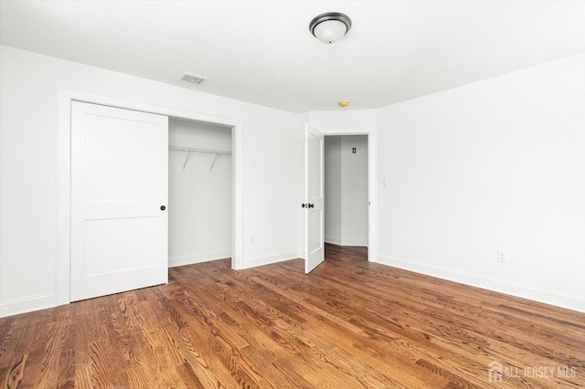 440 Ellisdale Rd, Chesterfield, NJ 08515 - unfurnished bedroom featuring baseboards, visible vents, wood finished floors, and a closet