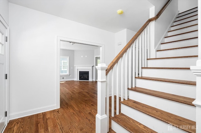 440 Ellisdale Rd, Chesterfield, NJ 08515 - stairway with baseboards, a fireplace, and wood finished floors