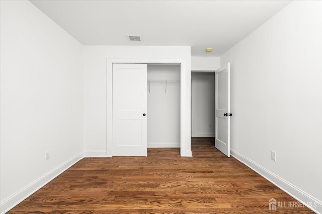 440 Ellisdale Rd, Chesterfield, NJ 08515 - unfurnished bedroom featuring baseboards, a closet, dark wood finished floors, and visible vents