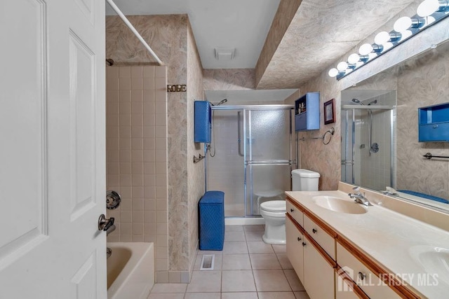 bathroom featuring tile patterned flooring, visible vents, double vanity, toilet, and a sink