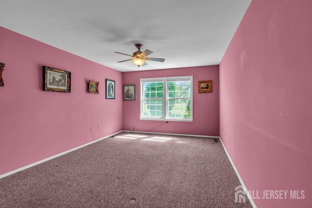 unfurnished room featuring carpet floors, ceiling fan, and baseboards