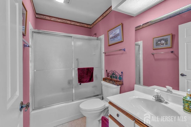 full bath with toilet, tile patterned flooring, shower / bath combination with glass door, and vanity