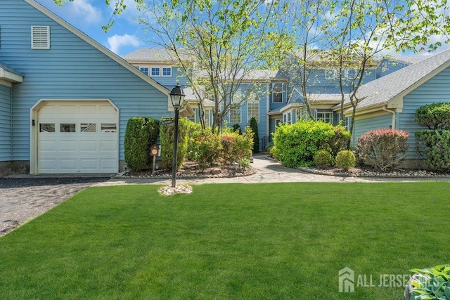 exterior space with an attached garage and aphalt driveway