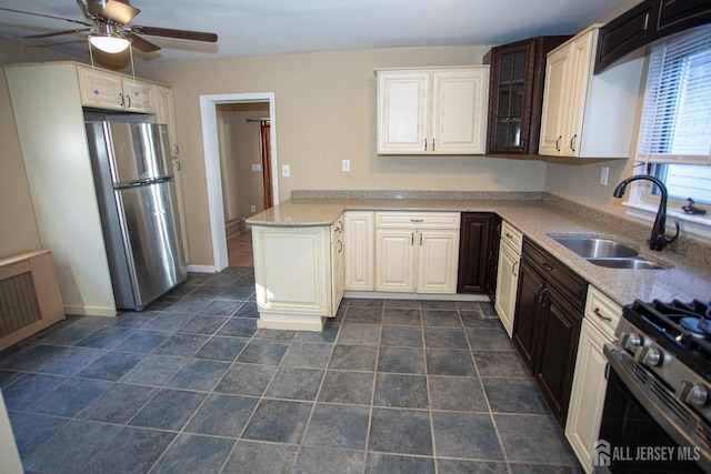 51 Shadyside Ave, Old Bridge, NJ 08879 - kitchen featuring a sink, stainless steel appliances, a ceiling fan, a peninsula, and glass insert cabinets