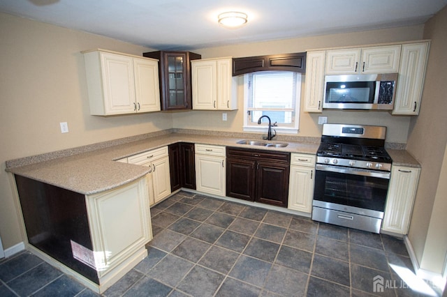 51 Shadyside Ave, Old Bridge, NJ 08879 - kitchen featuring a peninsula, glass insert cabinets, light countertops, a sink, and stainless steel appliances