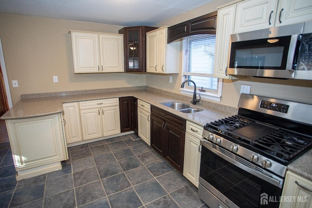 51 Shadyside Ave, Old Bridge, NJ 08879 - kitchen with a sink, appliances with stainless steel finishes, a peninsula, and glass insert cabinets
