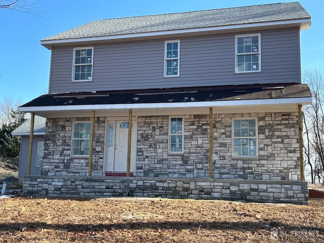 view of front of property with stone siding and a porch