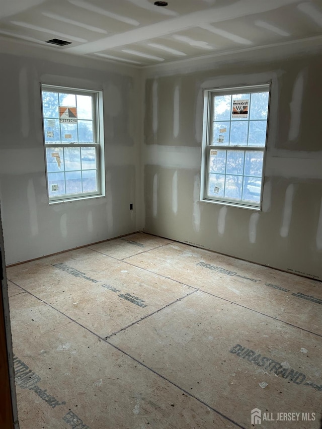 spare room featuring visible vents