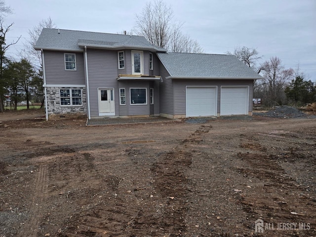 816 Rt 202nd Hwy, Readington, NJ 08853 - view of front of property featuring a garage, roof with shingles, dirt driveway, and stone siding