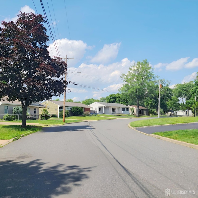 15 Clemson St, Old Bridge, NJ 08859 - view of asphalt street featuring curbs and street lighting