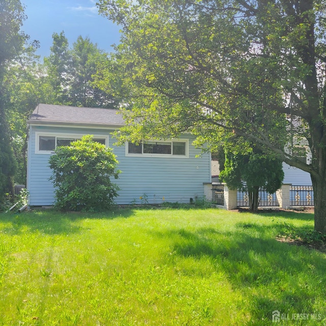 15 Clemson St, Old Bridge, NJ 08859 - rear view of property featuring a lawn