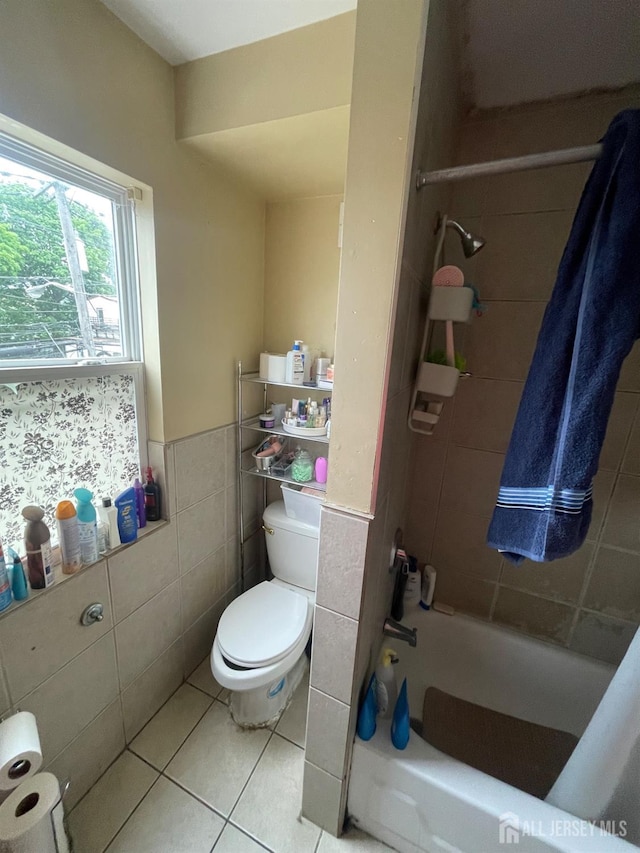 142 Joyce Kilmer Ave, New Brunswick, NJ 08901 - bathroom featuring toilet, tile walls, tile patterned flooring, washtub / shower combination, and wainscoting