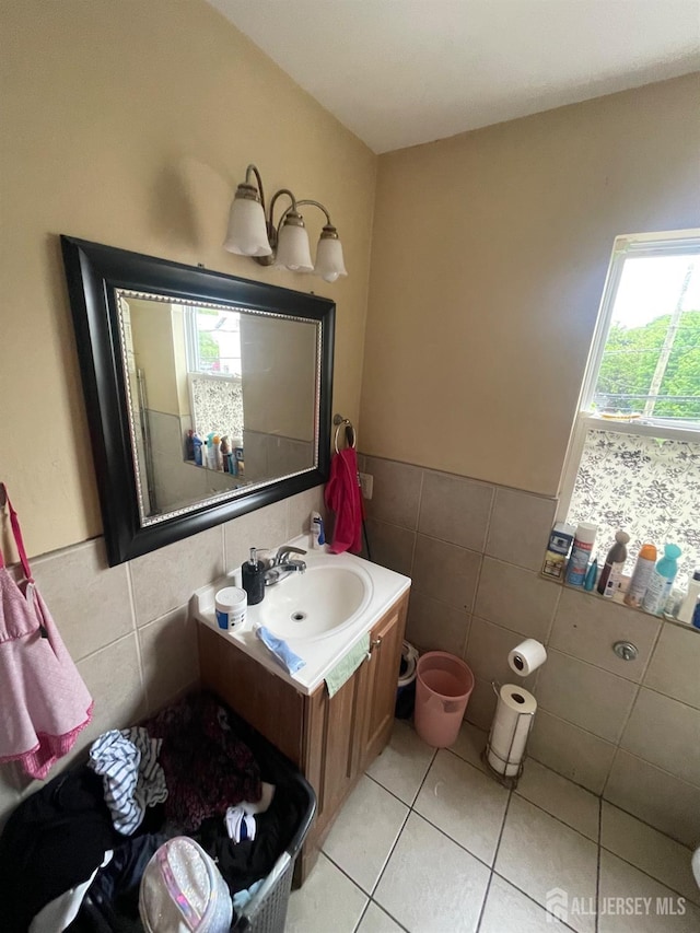 142 Joyce Kilmer Ave, New Brunswick, NJ 08901 - bathroom with tile walls, vanity, tile patterned flooring, and wainscoting