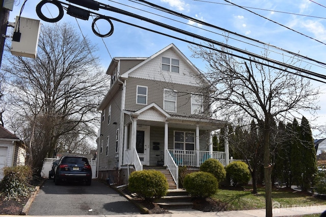 traditional style home featuring covered porch and stairs