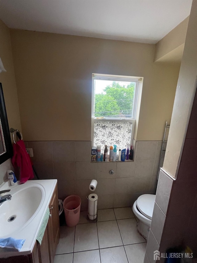 142 Joyce Kilmer Ave, New Brunswick, NJ 08901 - bathroom featuring tile walls, tile patterned flooring, vanity, a wainscoted wall, and toilet