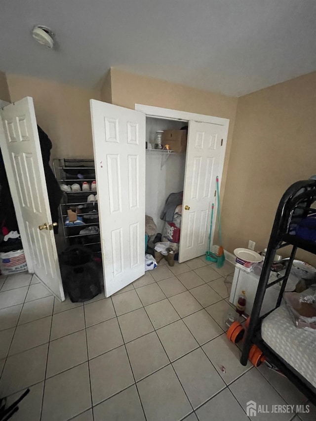 142 Joyce Kilmer Ave, New Brunswick, NJ 08901 - bedroom featuring light tile patterned floors and a closet