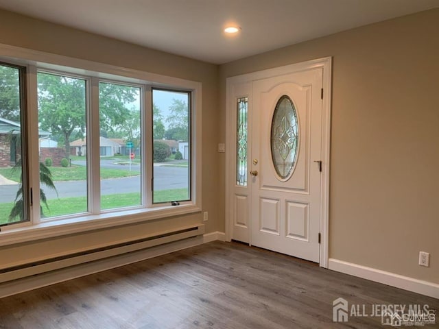 entryway featuring a baseboard heating unit, recessed lighting, wood finished floors, and baseboards