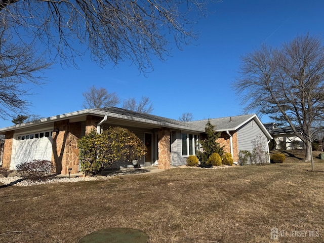 single story home with stone siding, an attached garage, and a front yard