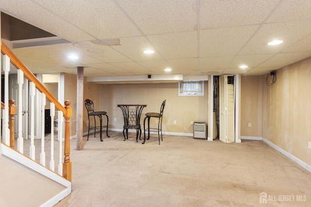 interior space featuring carpet flooring and a paneled ceiling