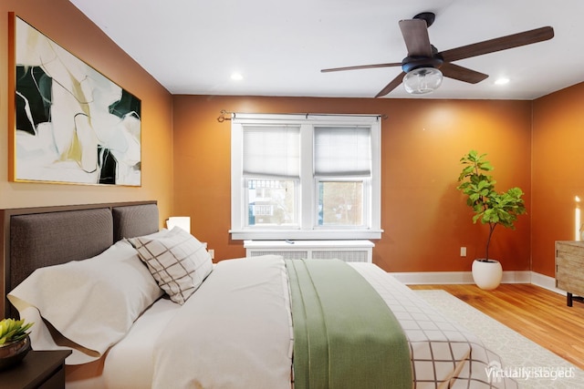 bedroom featuring ceiling fan and hardwood / wood-style flooring