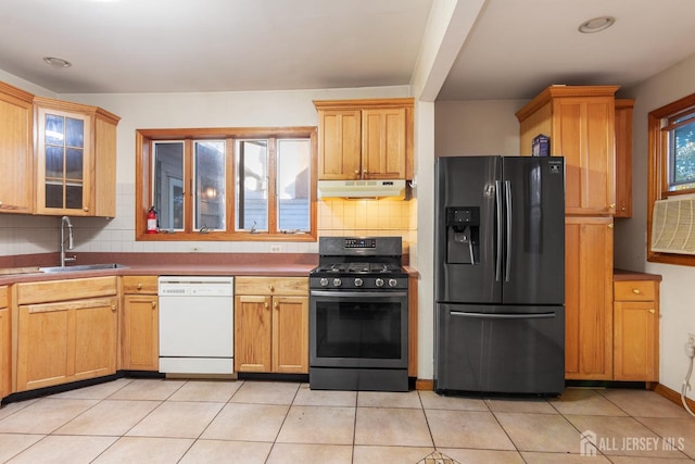 kitchen featuring tasteful backsplash, sink, light tile patterned floors, and stainless steel appliances