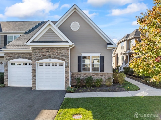 view of front of home with a garage and aphalt driveway