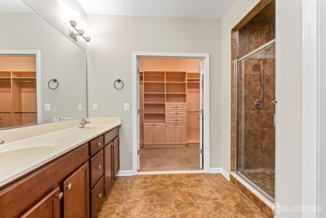 bathroom with vanity and a shower with shower door