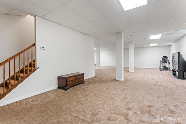 basement with carpet flooring and a drop ceiling