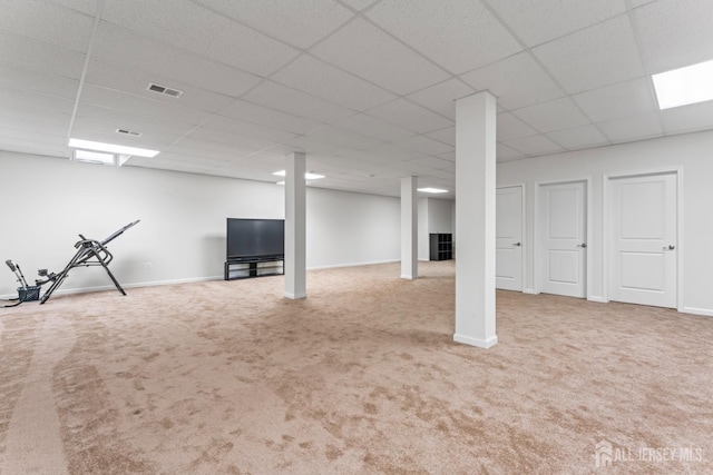 basement with carpet floors and a paneled ceiling