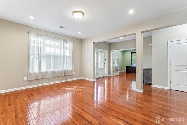 unfurnished living room featuring wood-type flooring