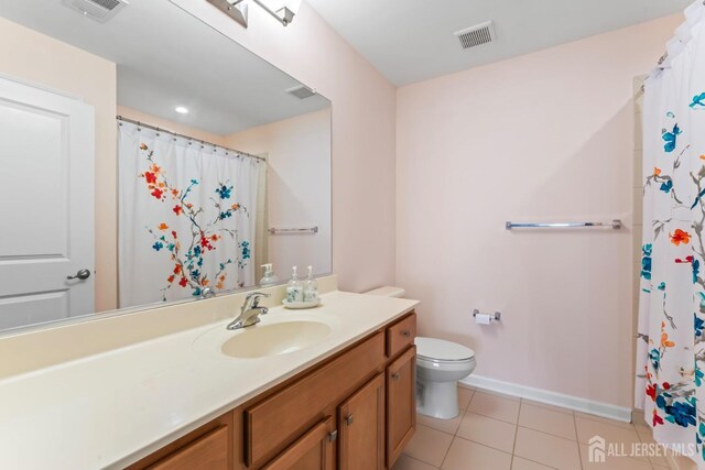 bathroom featuring vanity, curtained shower, tile patterned floors, and toilet