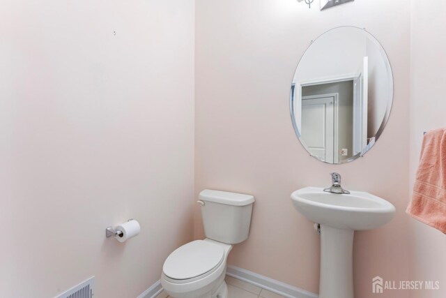 bathroom featuring tile patterned floors and toilet