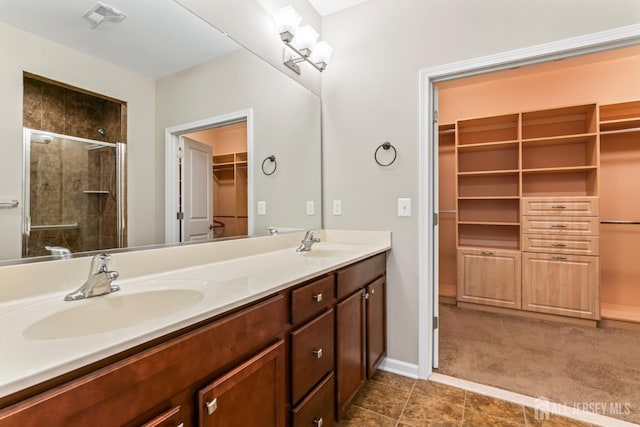 bathroom with vanity and a shower with shower door