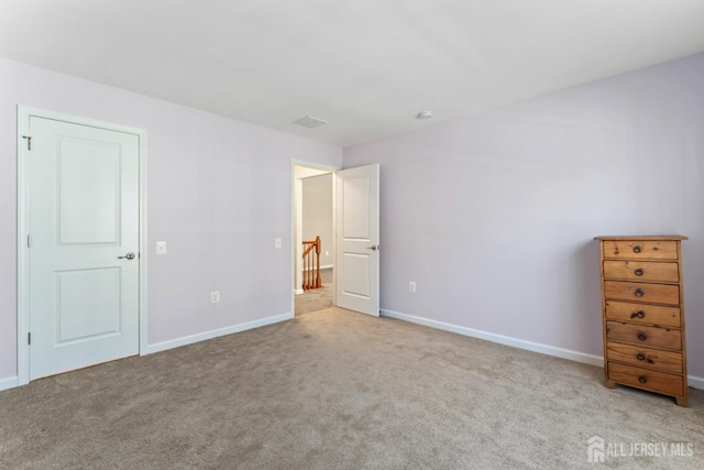 unfurnished bedroom with light colored carpet