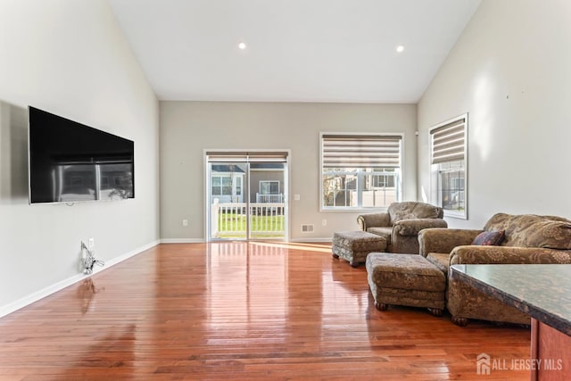 living room featuring vaulted ceiling and hardwood / wood-style floors