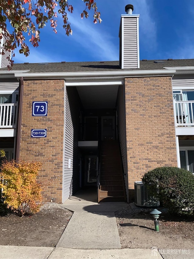 entrance to property featuring central AC unit