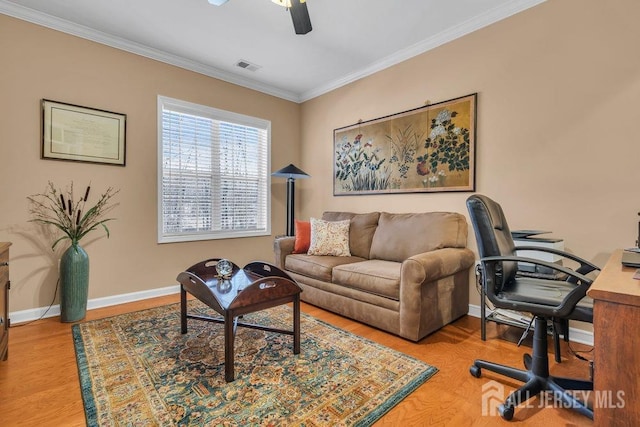 living room featuring baseboards, visible vents, wood finished floors, and ornamental molding