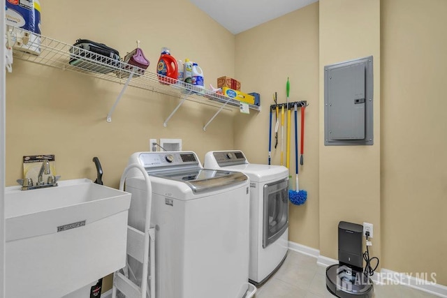 clothes washing area featuring light tile patterned floors, a sink, laundry area, electric panel, and independent washer and dryer