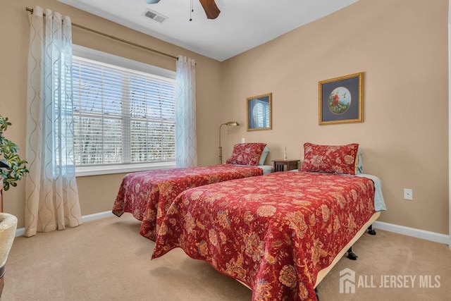 bedroom with carpet floors, visible vents, baseboards, and a ceiling fan