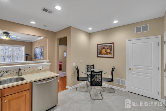 kitchen with a sink, visible vents, and dishwasher