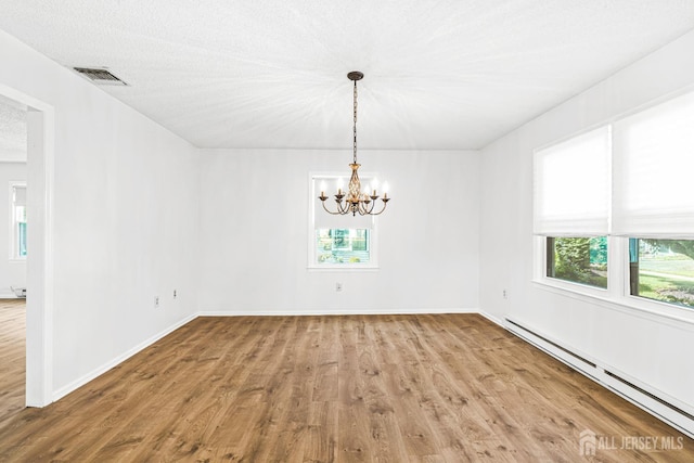 298-B Sharon Way, Monroe, NJ 08831 - unfurnished room featuring a baseboard radiator, wood finished floors, and a chandelier